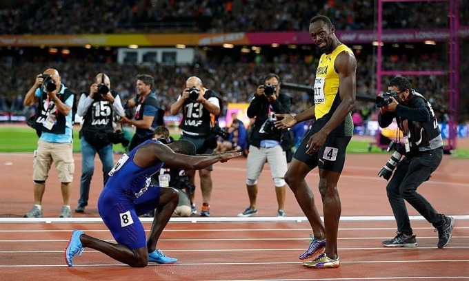 Gatlin quỳ gối thể hiện sự kính phục dù vừa đánh bại Bolt ở giải VĐTG 2017 tại London, giải đấu lớn cuối cùng trước khi Tia chớp Jamaica giải nghệ. Ảnh: AP