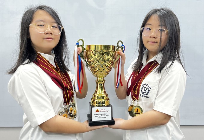 Chị em Minh Anh, Chi Anh giành cup vô địch phần tranh biện đồng đội tại cuộc thi vòng loại WSC, giữa tháng 4. Ảnh: Gia đình cung cấp