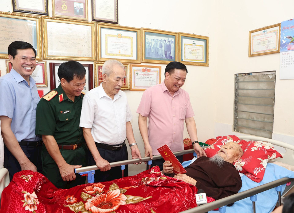 Bí thư Thành ủy Hà Nội Đinh Tiến Dũng thăm hỏi ông Nguyễn Cường Phương (phường Thịnh Liệt, quận Hoàng Mai), cán bộ tiền khởi nghĩa, dân công hỏa tuyến phục vụ Chiến dịch Điện Biên Phủ. Ảnh: Thanh Hải