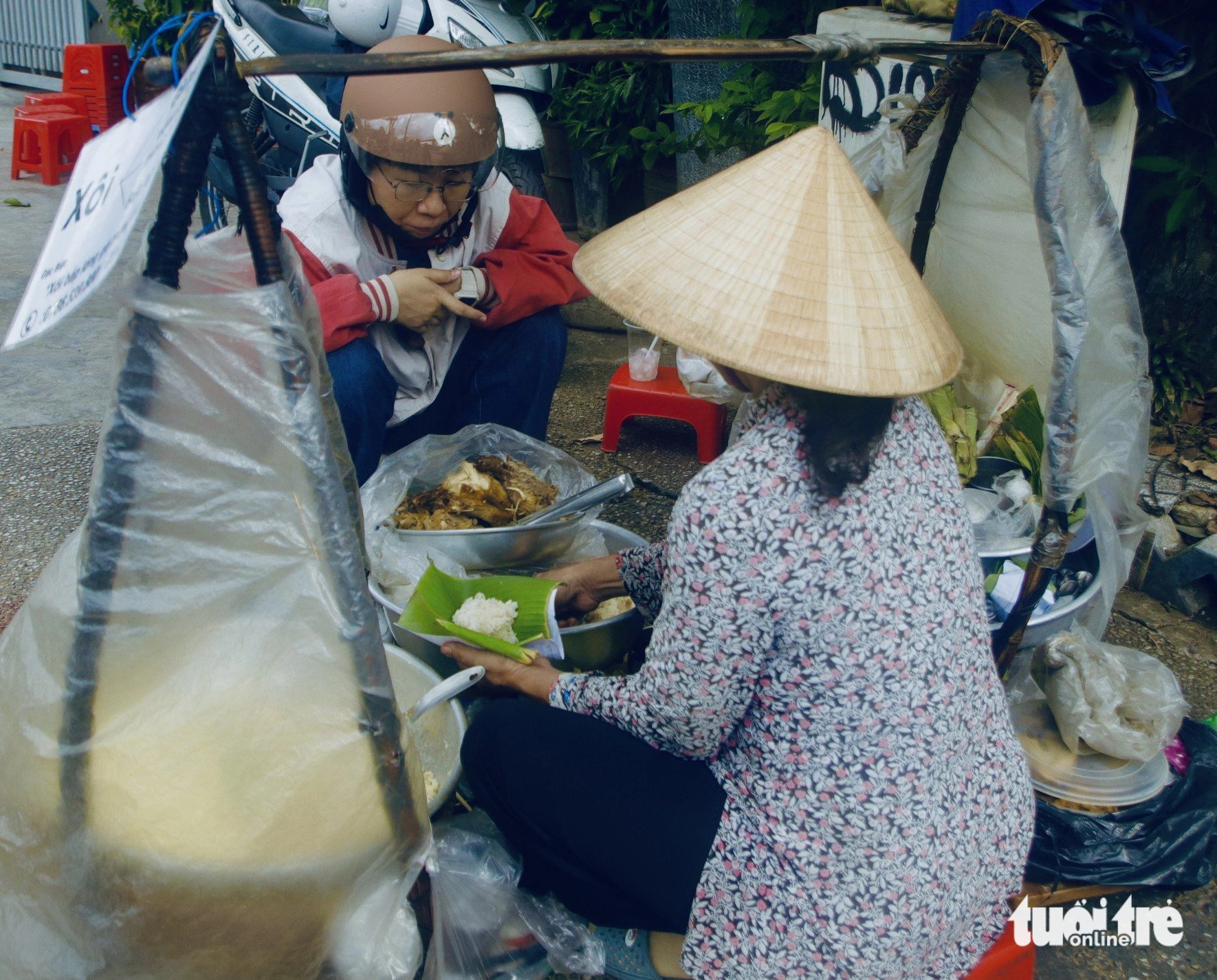 Gánh xôi gà cô Lệ hơn 30 năm ở ngã tư trung tâm Sài Gòn, đón nhận biết bao chân tình- Ảnh 6. Bà Lệ gói xôi cho khách