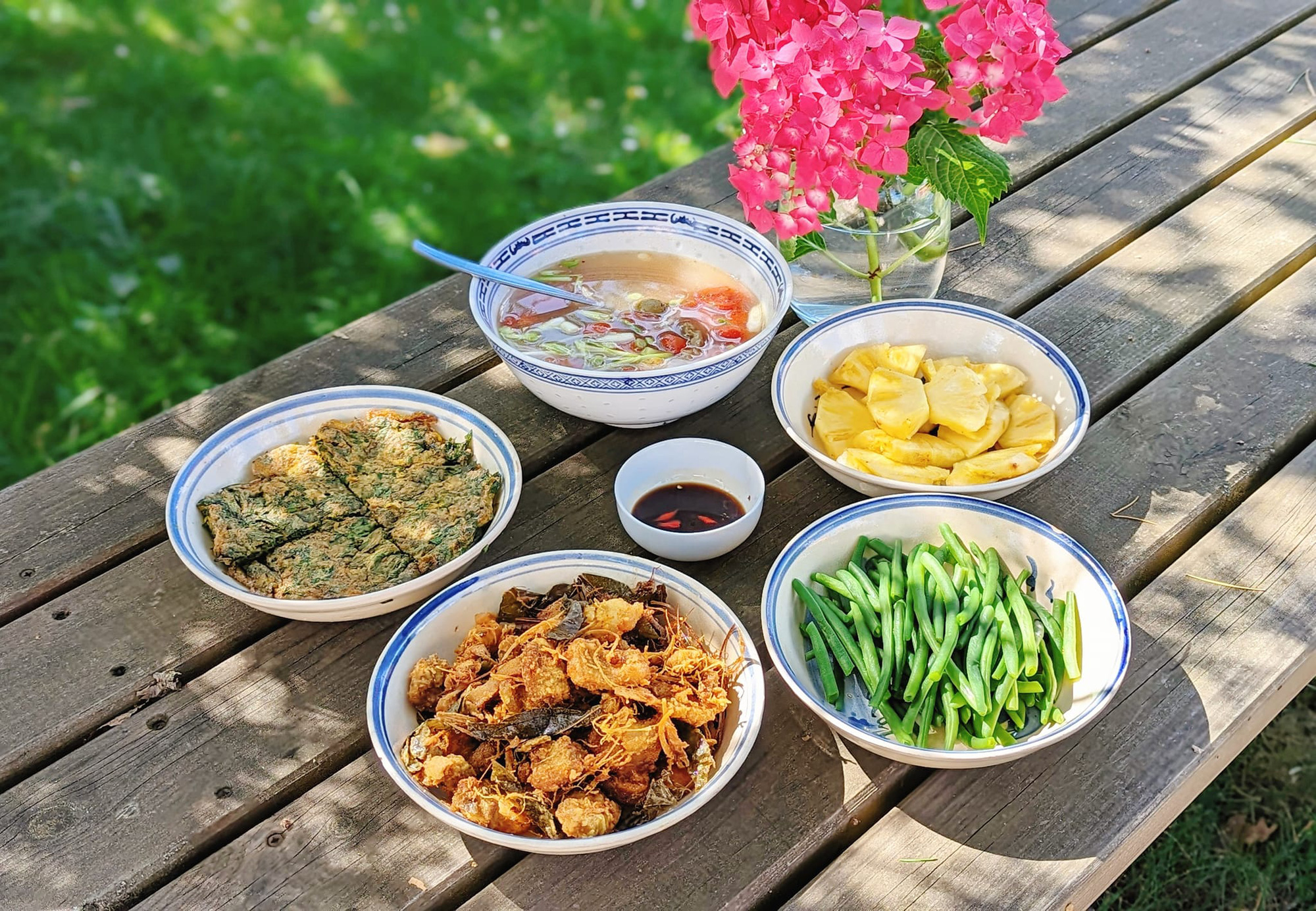Mâm cơm gồm trứng chiên ngải cứu, ba chỉ chao riềng mẻ lá mắc mật, đậu cô ve nhà trồng, cạnh thịt bằm sấu chua, dứa - Ảnh: NVCC Mâm cơm gồm trứng chiên ngải cứu, ba chỉ chao riềng mẻ lá mắc mật, đậu cô ve nhà trồng, canh thịt bằm sấu chua, dứa - Ảnh: NVCC