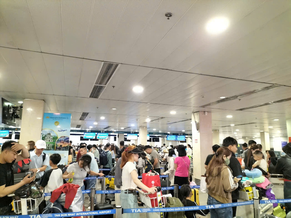 Càng về sáng, lượng khách đổ về sân bay Tân Sơn Nhất càng đông đúc và tiếp tục phải rồng rắn xếp hàng chờ làm thủ tục, nhưng may mắn không bị quá tải. Ảnh: Tiểu Thúy